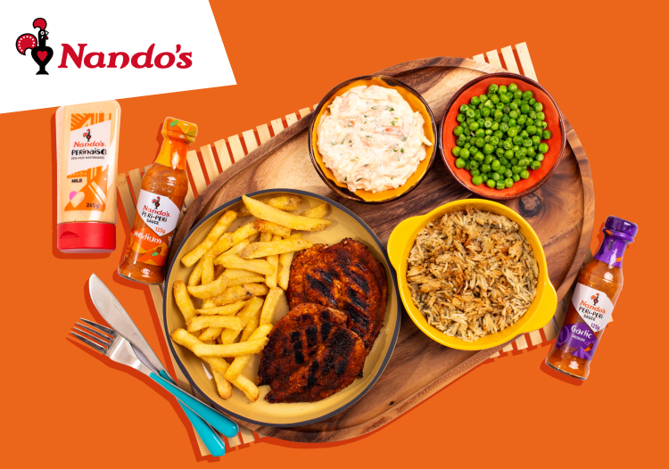 A meal with Nando's sauces laid out on a wooden board