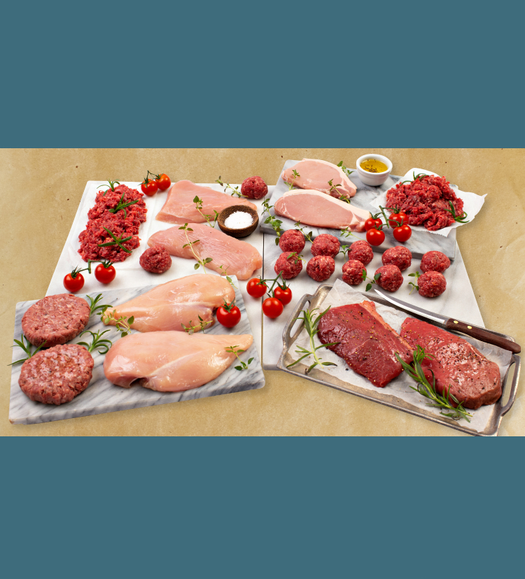 A variety of raw meats arranged on chopping boards