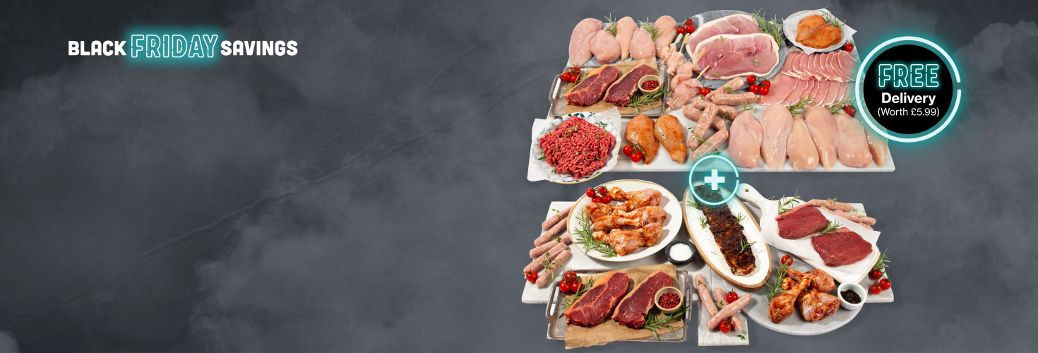 a large selection of meat arranged on two marble chopping boards