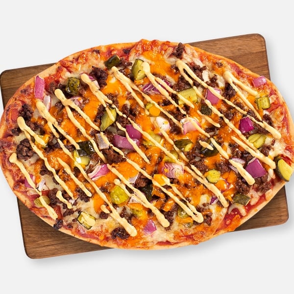 Cheeseburger pizza on a wooden board