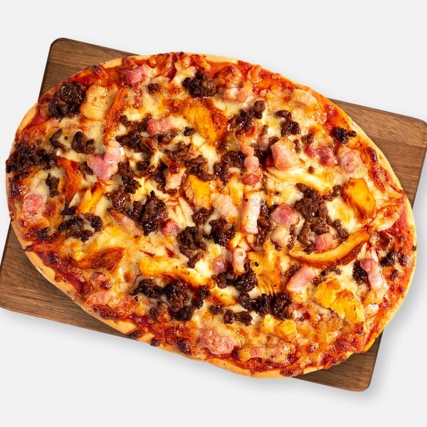 Mighty Meaty pizza on a wooden board