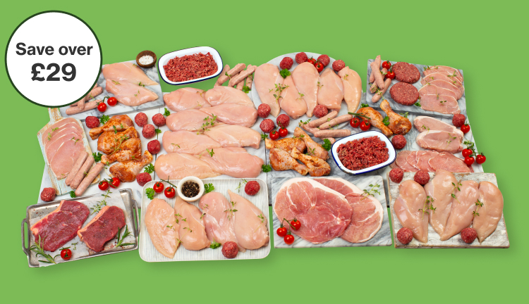 a large selection of raw meats arranged on baking trays